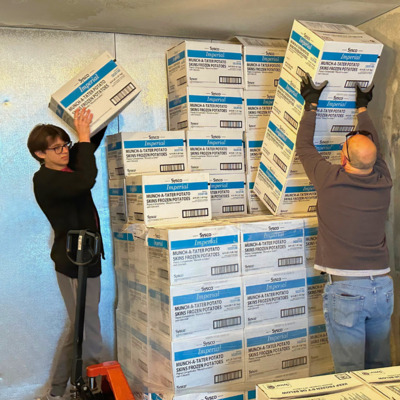 Volunteers downstacking in the freezer.