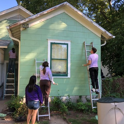 Habitat Repair team painting a house